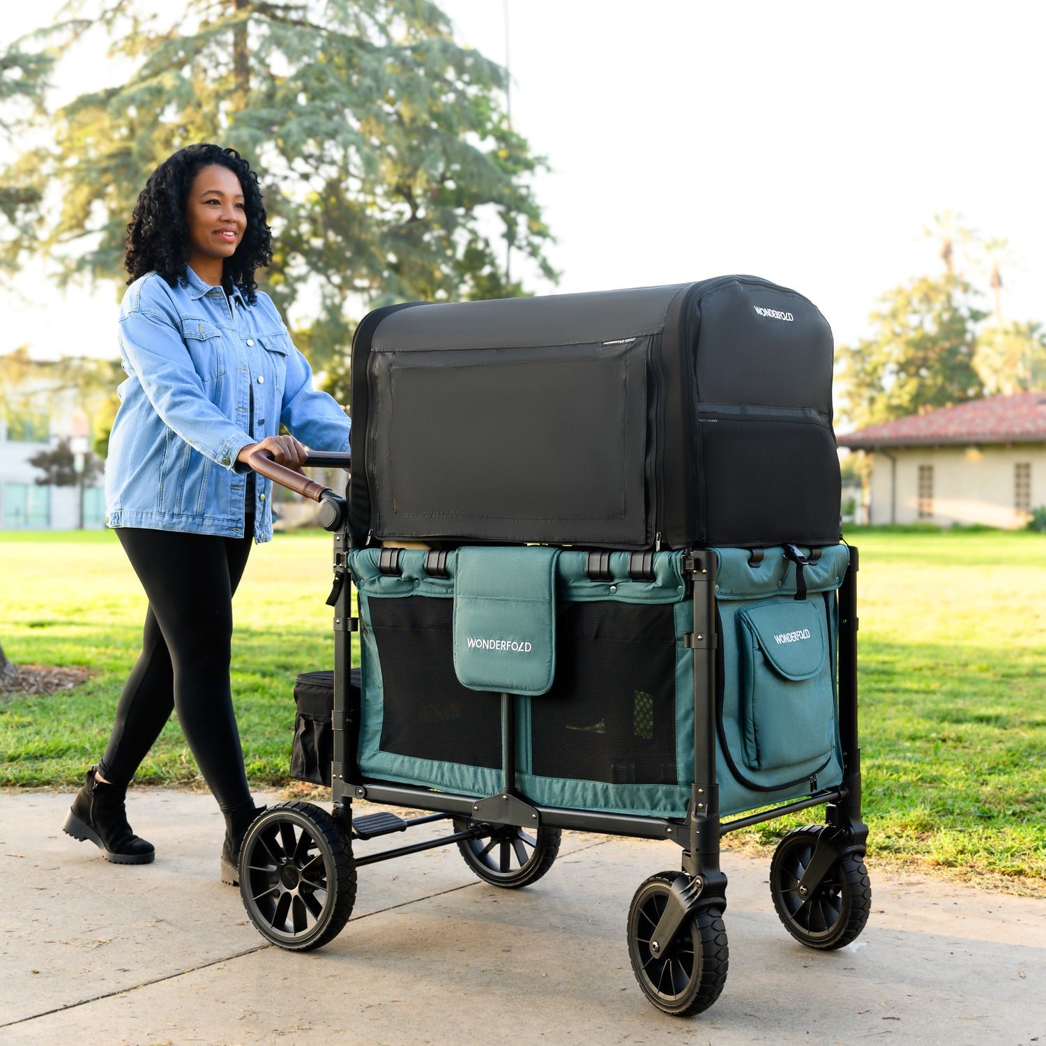mom pushing kid stroller wagon with full coverage canopy