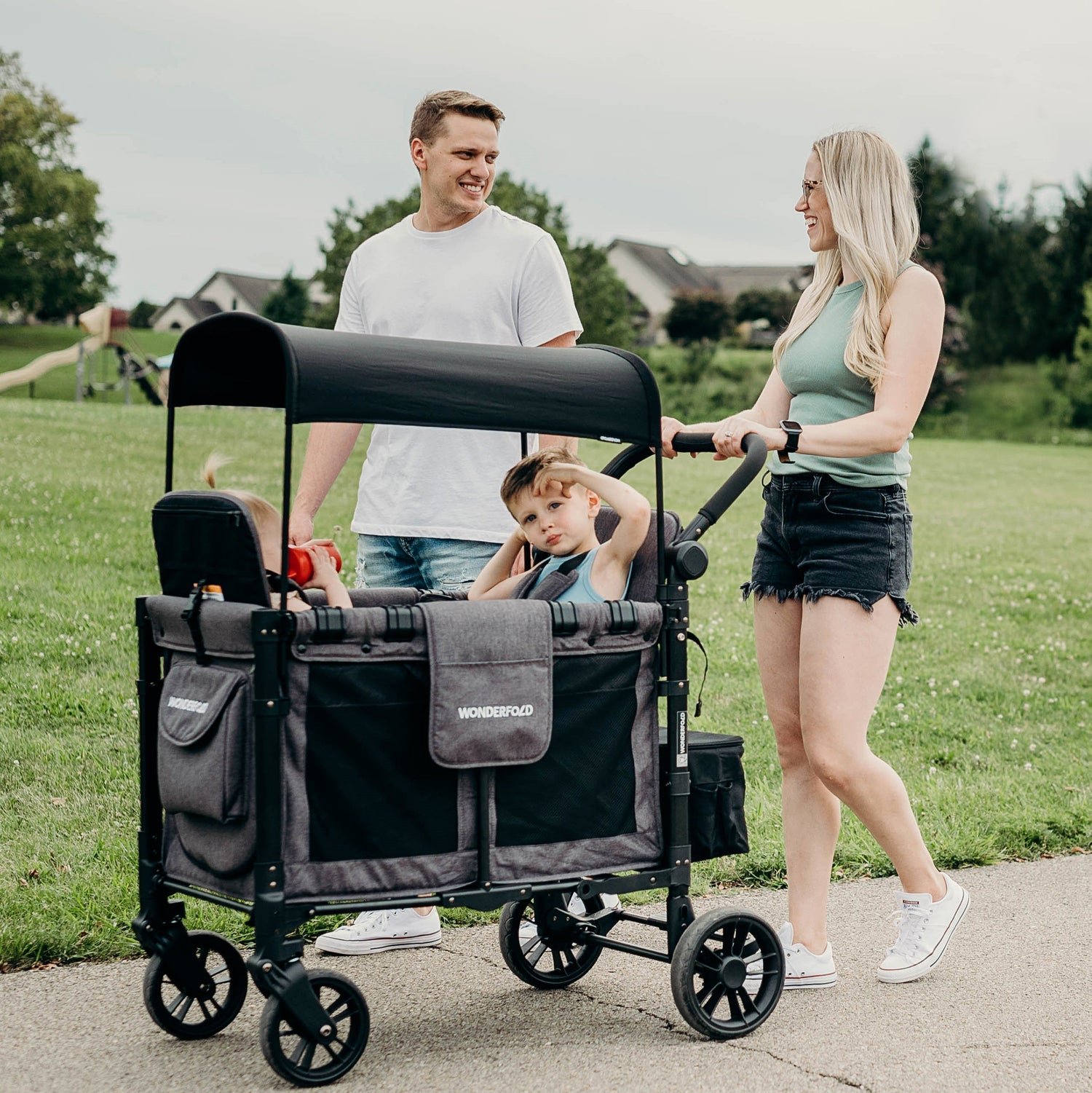 Parents pushing two kids in a W2 Stroller Wagon - Lifestyle image