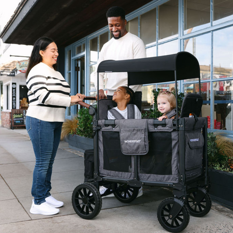 Family enjoying a day out with the W2 Luxe Pro 2-seater wagon, featuring a removable canopy for added comfort