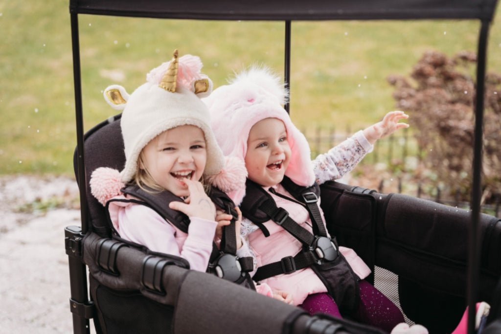 Kids dressed for fall enjoying a ride in a WonderFold stroller wagon