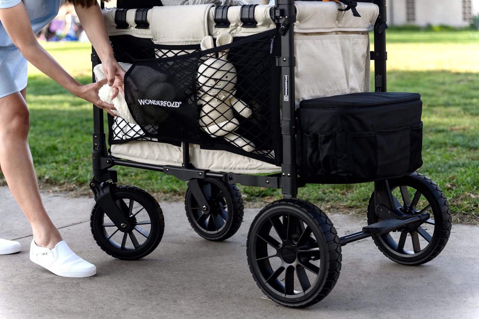 WonderFold wagon featuring the WonderNet Cargo Net for extra side storage, shown holding a stuffed animal and essentials