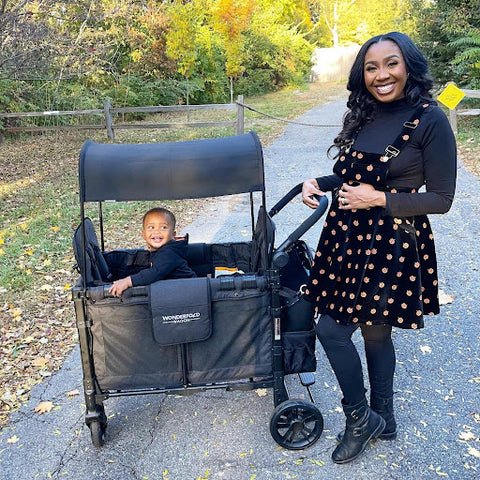A mom and her toddler enjoying an autumn scenery